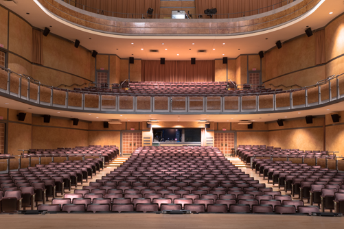 The interior of the George Weston Recital Hall at the Meridian Arts Centre. Looking from the stage into the empty audience, the image shows three levels of seating in the spacious theatre.