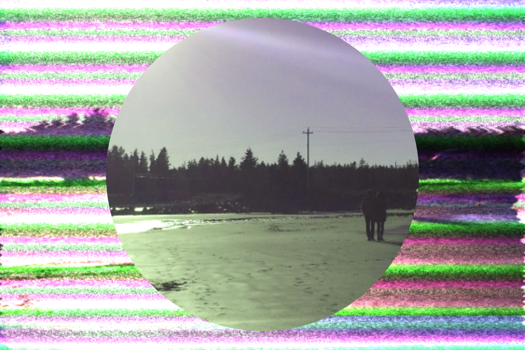 Two people walking along the shore with the sun gleaming off the sand. Behind the circular frame is the same image, blurred and distorted like on a fuzzy tv screen.
