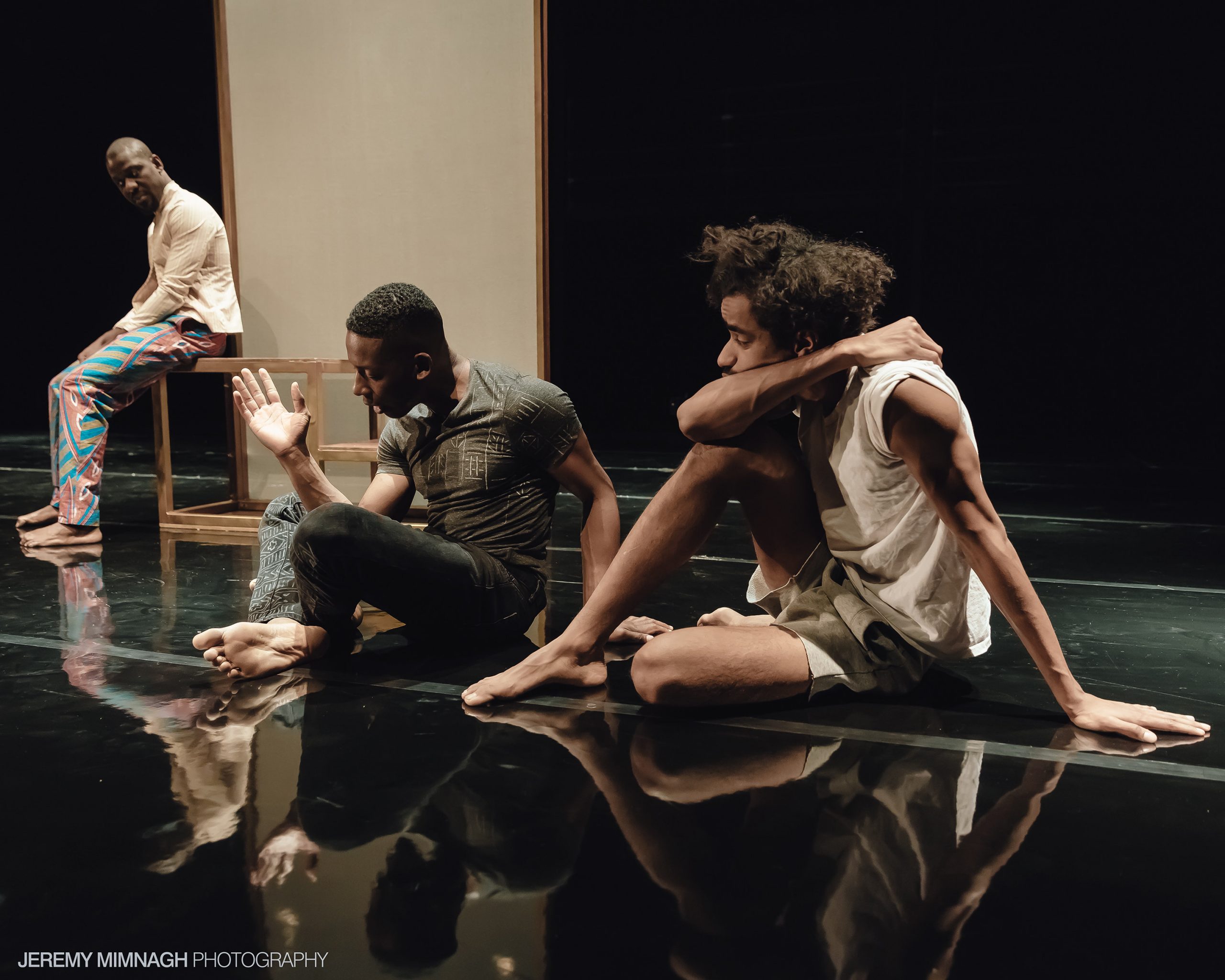 Tawiah Ben M'Carthy, Tjomas Olajide and Stephen Jackman-Torkoff on stage in Buddies' 2016 production of Black Boys.