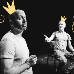 A greyscale image of Daniel Krolik and Jonathan Wilson, the stars of "Gay For Pay with Blake & Clay." Posed on a black background, Daniel looks directly into the camera, his hands clasped in front of him; behind him, Jonathan sits in a chair facing Daniel, his right arm outstretched. Small, yellow cartoony crowns float above both of their heads, and intricate yellow swirls float beside them, emphasising their positions.