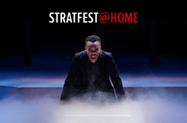 Amaka Umeh as the titular prince in Stratford Festival's 2022 production of Hamlet. She crouches onstage, facing the camera, shouting intently at her audience. Smoke billows from the stage around her hands. Above her head is the red and white logo for STRATFEST@HOME. Original Photo by David Hou. Image courtesy of Stratford Festival.