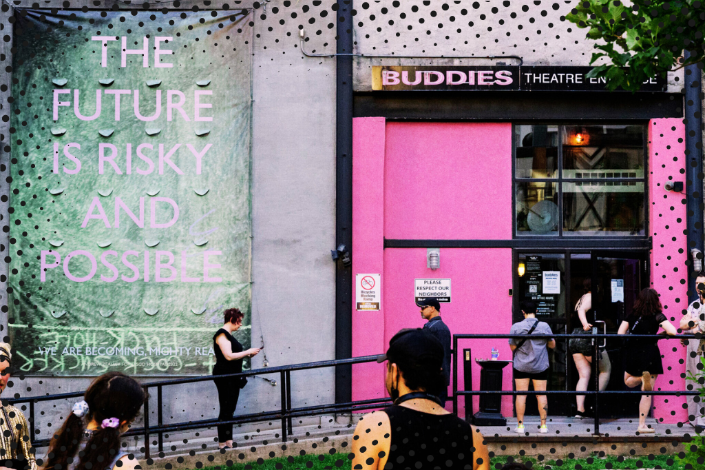 The exterior of Buddies in Bad Times Theatre. The bubblegum-pink double doors are open, allowing a crowd of visitors to enter. Above the door is the company's logo, also in pink. To the left of the door, a large green banner hangs against a concrete wall. Pale pink text on the banner reads "THE FUTURE IS RISKY AND POSSIBLE." Image courtesy of the Buddies in Bad Times website.