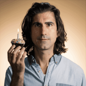 Photo of Aidan deSalaiz holding a cupcake.