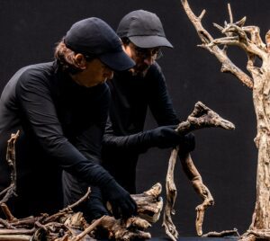 Performers holding performance props.