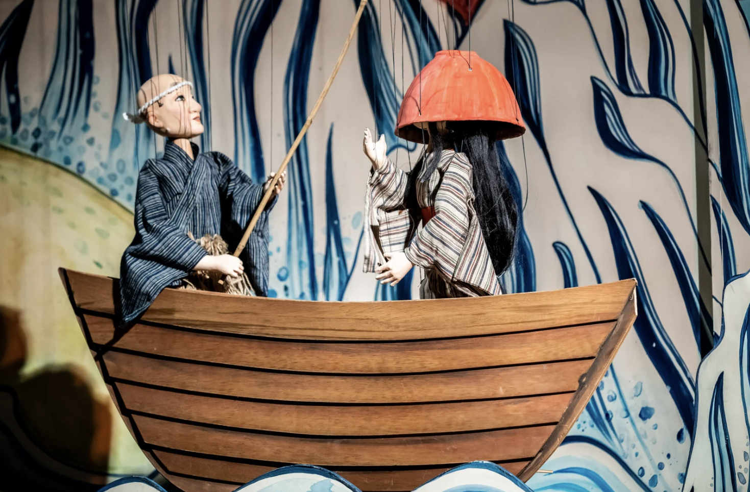 String puppets on a fishing boat