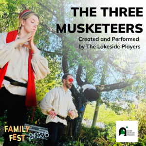 Two actors perform outdoors in flowy white shirts. One wears a red vest, and the other wears a red mask.