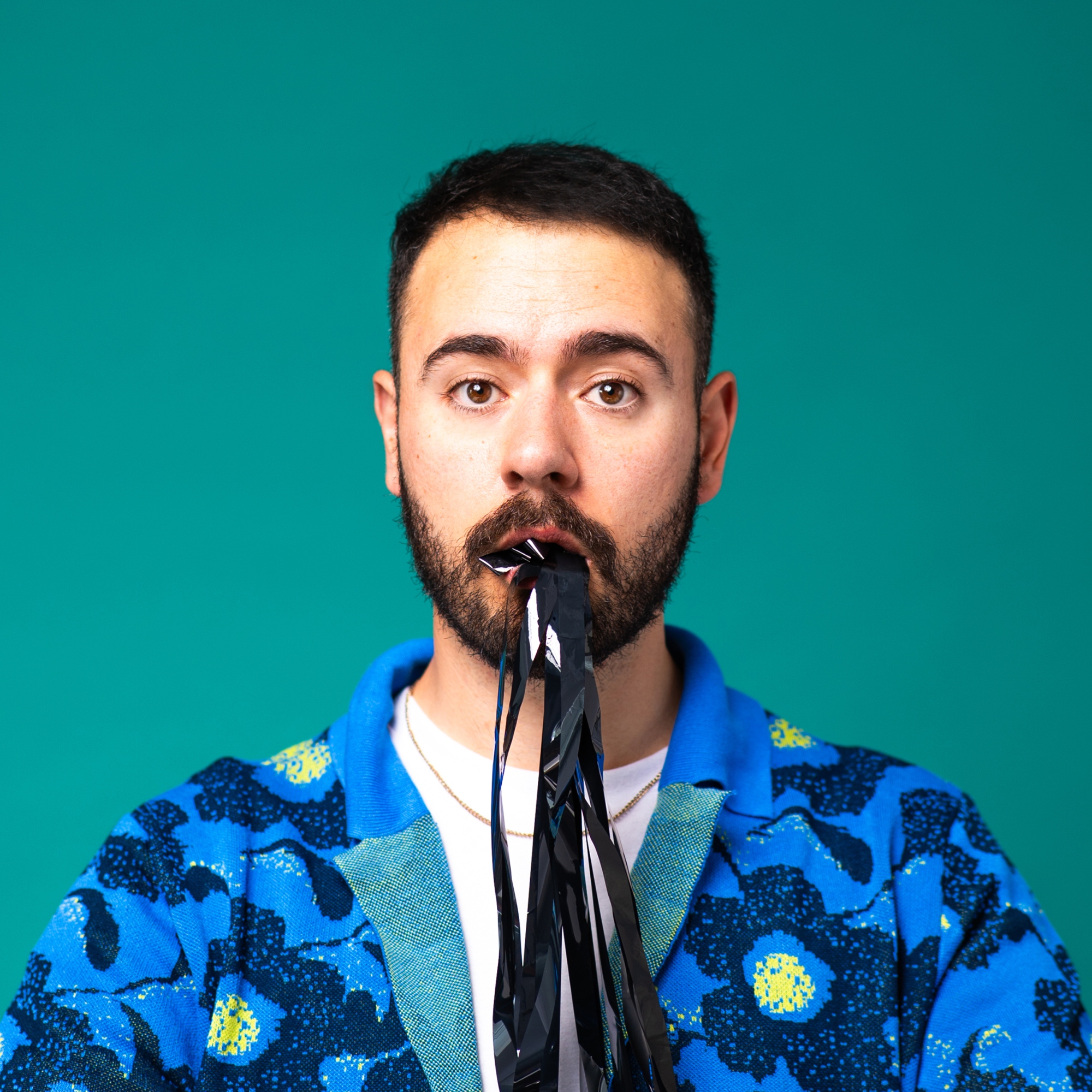 A white man with black recording tape in his mouth.